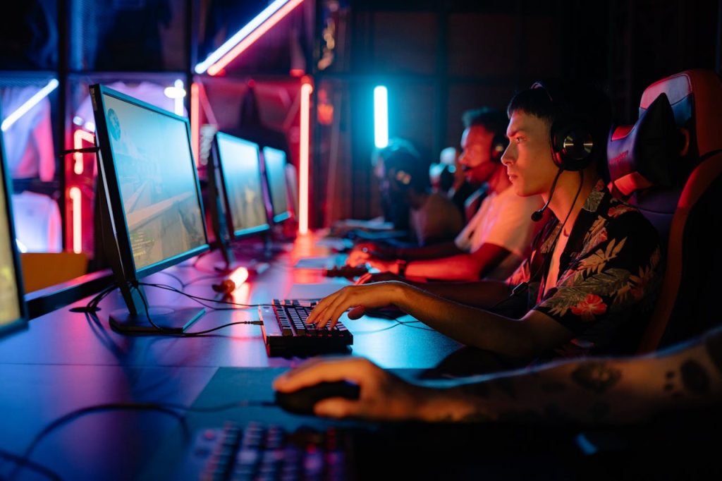 Group of gamers immersed in competitive esports at a cyber arena with neon lighting.